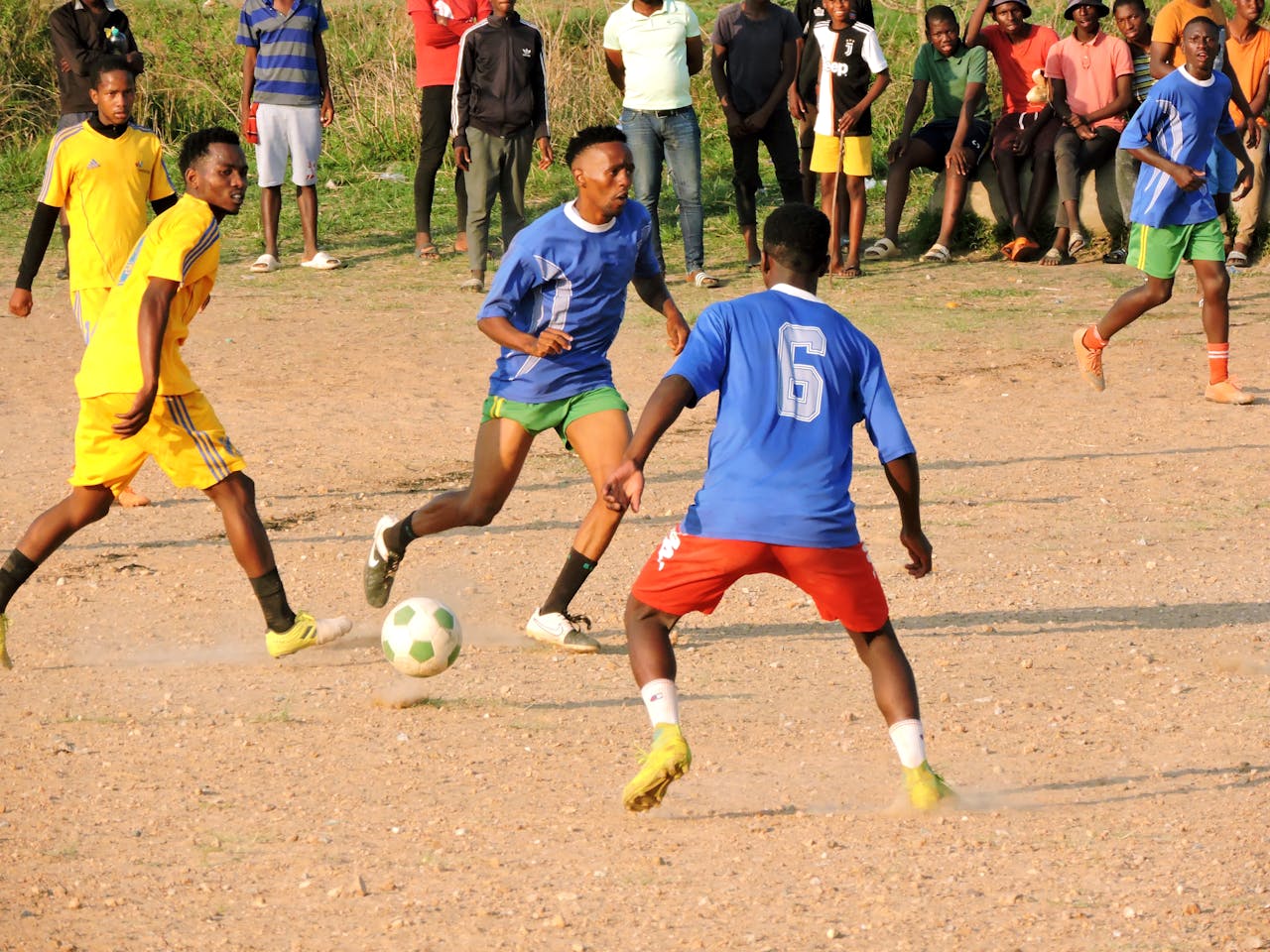 Exciting soccer match in Lobamba, Eswatini with local teams and lively audience.